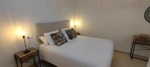 a bedroom with a white bed with two pillows at La Figar,apartamento con piscina, playa a 3km VUT-4390-AS in Llanes