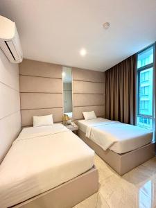 a bedroom with two beds and a window at SANG Hotel Apartment Sai Gon in Ho Chi Minh City