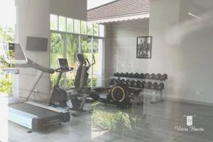 a room with a gym with a treadmill and weights at Verse House in Pontianak