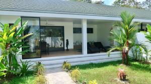a home with a screened in porch at Jasmine Village in Rawai Beach