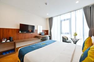 Postel nebo postele na pokoji v ubytování PLUS VUNG TAU HOTEL