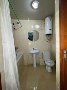 a bathroom with a toilet and a sink and a bath tub at Аэропорт Астана 5 минут юг1 in Astana
