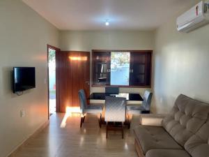 a living room with a couch and a table at Casa 4 - Vila Francisco in Pirenópolis