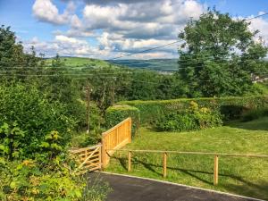 a wooden stairway leading down to a garden with a view at Ty Howton in Clydach