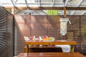 a bowl of fruit sitting on a wooden table at Shirley Beach House, right in heart of Byron Bay, walking distance to town and most famous beaches in Byron Bay +25 photos