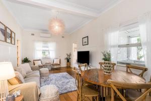 a living room with a table and a couch at Shirley Beach House, right in heart of Byron Bay, walking distance to town and most famous beaches in Byron Bay