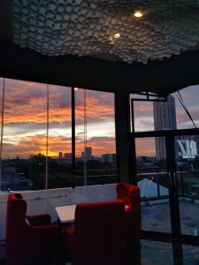 a room with a table and chairs and a sunset at Moritz Biz Gandaria in Jakarta