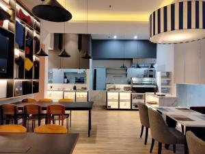 a large kitchen with a table and chairs at Moritz Biz Gandaria in Jakarta
