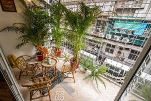 a patio with tables and chairs and a large window at Homestay Hang Tre 5min to Bar street in Hanoi