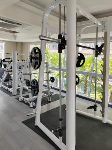 a gym with a row of tread machines at Romantic beach apartment芭堤雅水系高档酒店式公寓可做饭 in Jomtien Beach