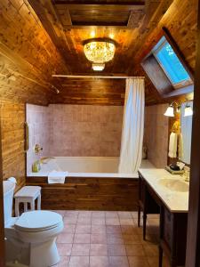 a bathroom with a tub and a toilet and a sink at Manor House Inn in Norfolk +115 photos