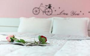 a bed with a book with a bike on it at Sunbeach Pension in Geoje 