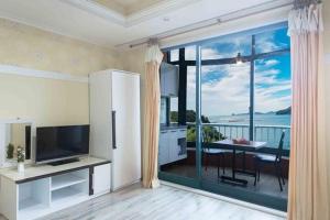 a living room with a view of the ocean at Sunbeach Pension in Geoje 
