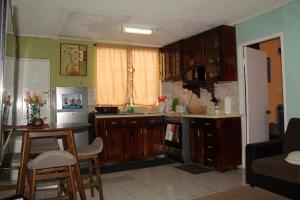 a kitchen with wooden cabinets and a counter top at Serenity at the Oxford in Kingston