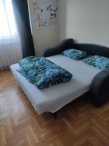 two beds in a room with two pillows on them at Kalina Apartment in Dušanovac (historical)
