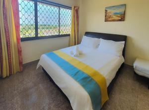 um quarto com uma cama grande e uma janela em 'Sunny seaview condo' at Regency by Shine Stay em Porto Dickson