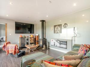 a living room with two couches and a fireplace at Pendle View Lodge in Altham