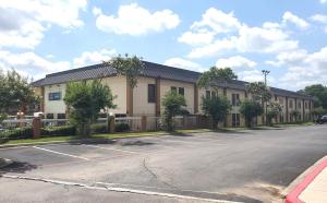 an empty parking lot in front of a building at Coratel Inn & Suites by Jasper New Braunfels IH-35 EXT 189 in New Braunfels