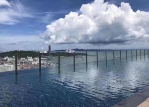 a large body of water with poles in the water at The BASE Central PATTAYA 2Bed on Sky in Pattaya