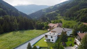 an aerial view of a house and a road in a valley at Chalet Samont in Laion
