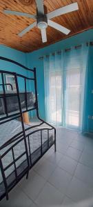 a bedroom with two bunk beds and a ceiling fan at Tranquility Base in Neapoli Voion