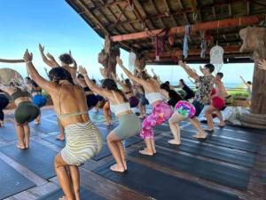 a group of people doing yoga on the beach at Udara Bali Yoga Detox & Spa in Canggu