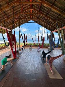a group of people doing yoga in a pavilion at Udara Bali Yoga Detox & Spa in Canggu