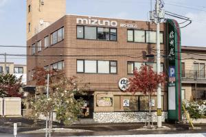 a brown brick building with a nikko restaurant at The MOON in Sapporo