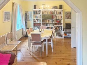 a dining room with a table and chairs and bookshelves at 7 person holiday home in ÄLGARÅS-By Traum in Skagen