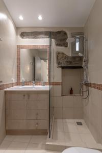 uma casa de banho com um lavatório e um chuveiro em Marousas Place em Agkidia