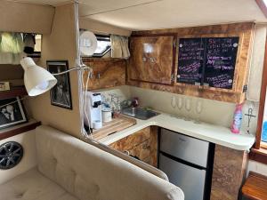 a kitchen in an rv with a sink and a counter at Studio 54 Themed Boat St. Tropez in Providence