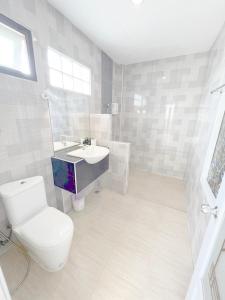 a bathroom with a toilet and a sink at On Green Resort in Ban Huai Sua