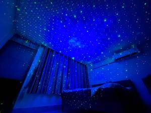 a bedroom with a blue ceiling with stars on it at Paradise Found - Hat Yai 292sqm Family Home in Hat Yai