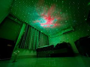 a room with a galaxy mural on the ceiling at Paradise Found - Hat Yai 292sqm Family Home in Hat Yai