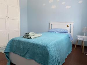 a bedroom with a bed with a blue blanket on it at B&B Campi di sole in Sala Bolognese