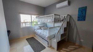 a small room with a bunk bed and a staircase at Private Villa in Gated Community Pet-Friendly in Cabo San Lucas
