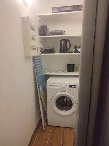 a laundry room with a washing machine and a washer at Maison avec piscine, jacuzzi et sauna in Saint-Nabord