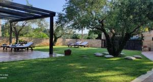 two picnic tables and a tree in a yard at Casa Alice in Rovinj