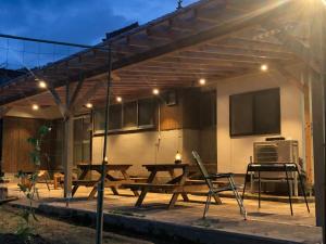 a patio with a picnic table under a pergola at Hatake no Oyado - Vacation STAY 73522v in Takeda