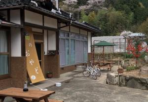 a building with a picnic table and bikes parked outside at Hatake no Oyado - Vacation STAY 73522v in Takeda