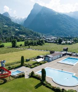 an aerial view of a resort with a pool and mountains at Le Duplex Septimontain in Samoëns