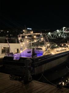 a boat is docked at a dock at night at Studio 54 Themed Boat St. Tropez in Providence +10 photos