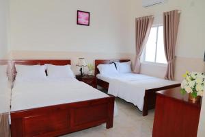 Postel nebo postele na pokoji v ubytování Magnolia Hotel Cam Ranh