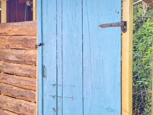 a blue door on the side of a building at Holiday home ÖDEBORG in Herräng