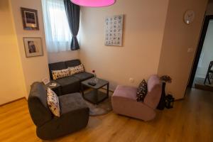 Sala de estar con 2 sofás y mesa en Charming Apartment in Shtip's downtown, en Štip