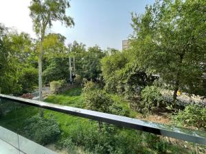 a view of a garden from the balcony of a building at BedChambers Luxurious Serviced Apartment in Gurgaon in Gurgaon