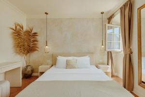 a bedroom with a white bed and a window at Vila Perast Boutique Hotel in Perast