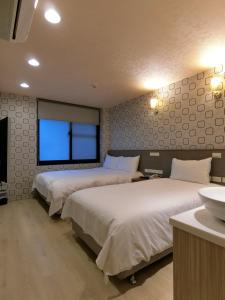 Postel nebo postele na pokoji v ubytování Taiwan Seven Days Boutique Hotel