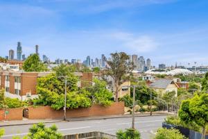 a city street with a city skyline in the background at South Yarra apartment with stunning views in Melbourne