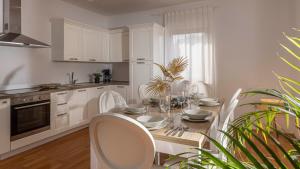 a white kitchen with a table and chairs in it at Val Piana in Savudrija